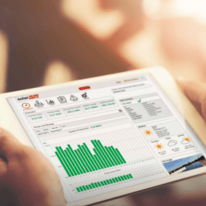 A person holding an ipad displaying a graph showing solar panel data.