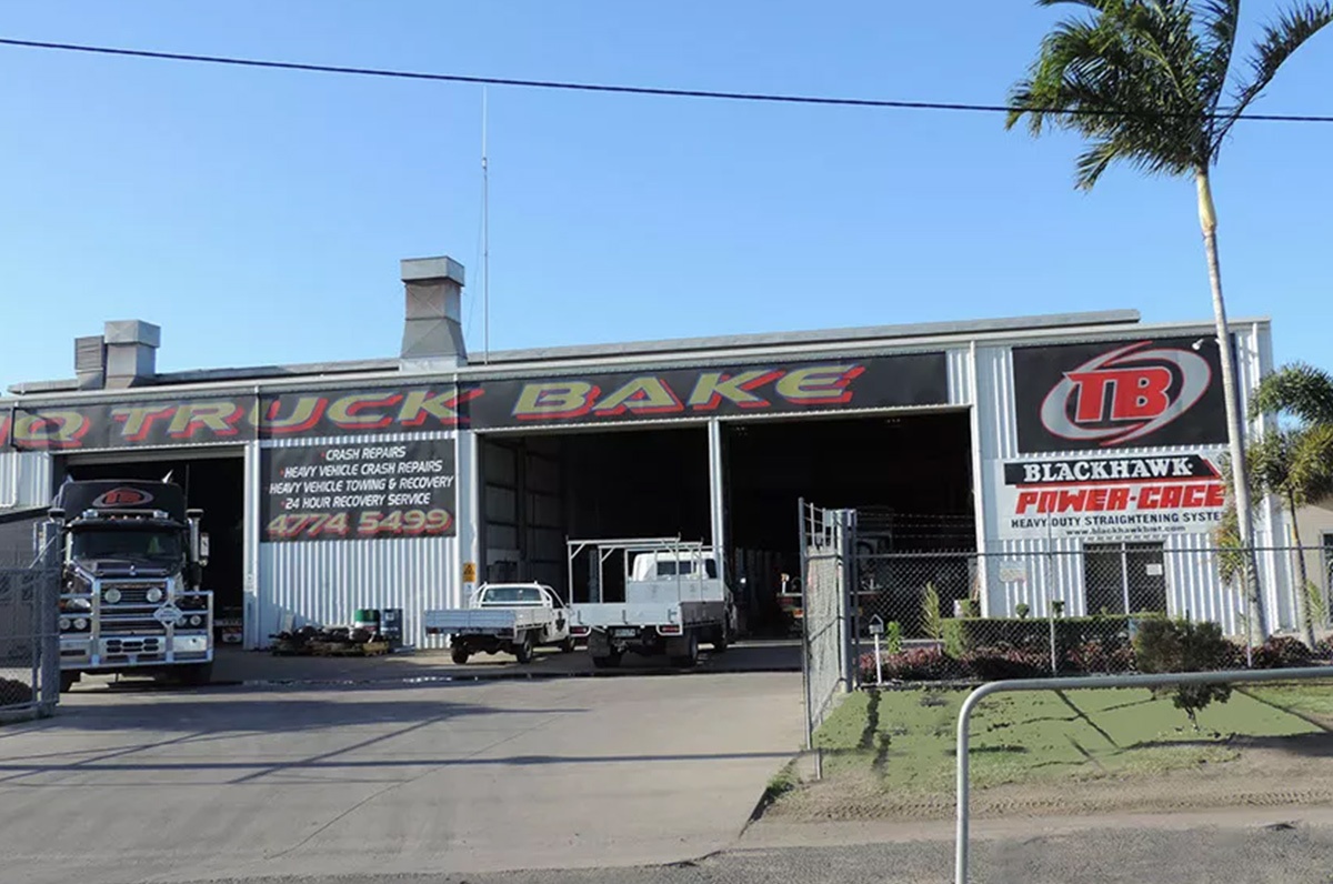 A truck is parked in front of a building that says Hielscher Electrical.