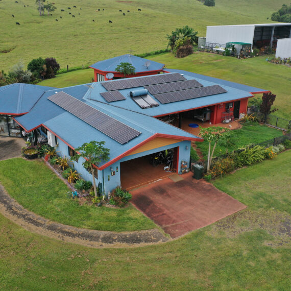 An aerial view of a home with solar panels on the roof in Cairns.