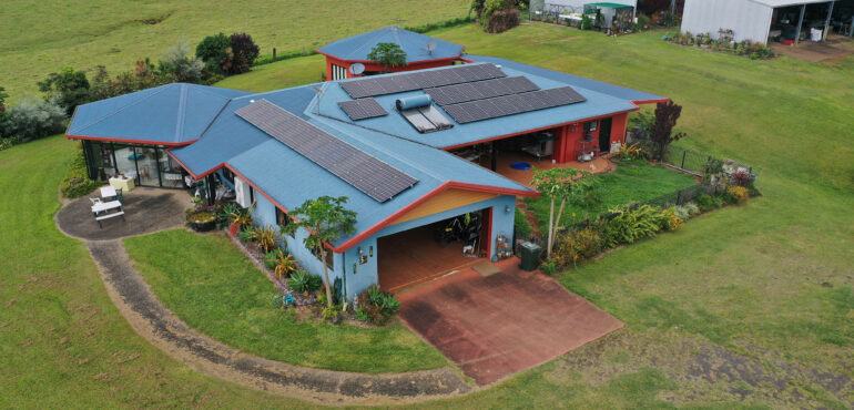 An aerial view of a home with solar panels on the roof in Cairns.
