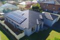 An aerial view of a house with solar panels on the roof, harnessing the power of the sun.
Keywords: Solar Power