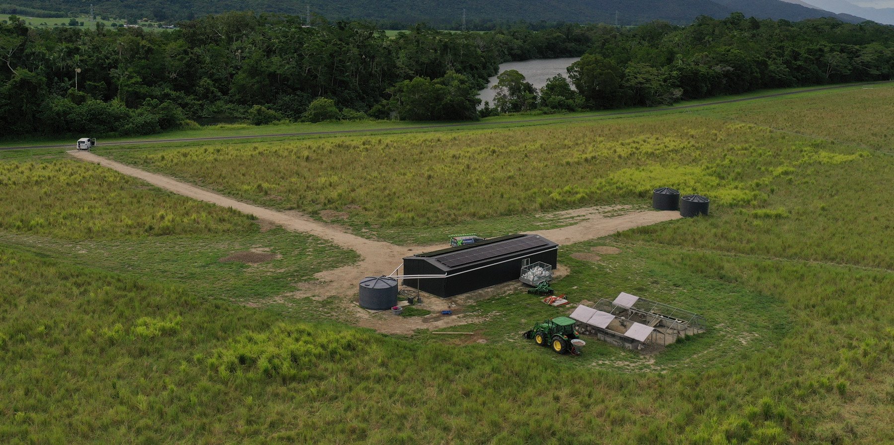 An aerial view of a farm in a field, featuring Hielscher Electrical's innovative solar power installation.