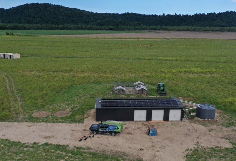 An aerial view of a Solar Power farm in the middle of a field.