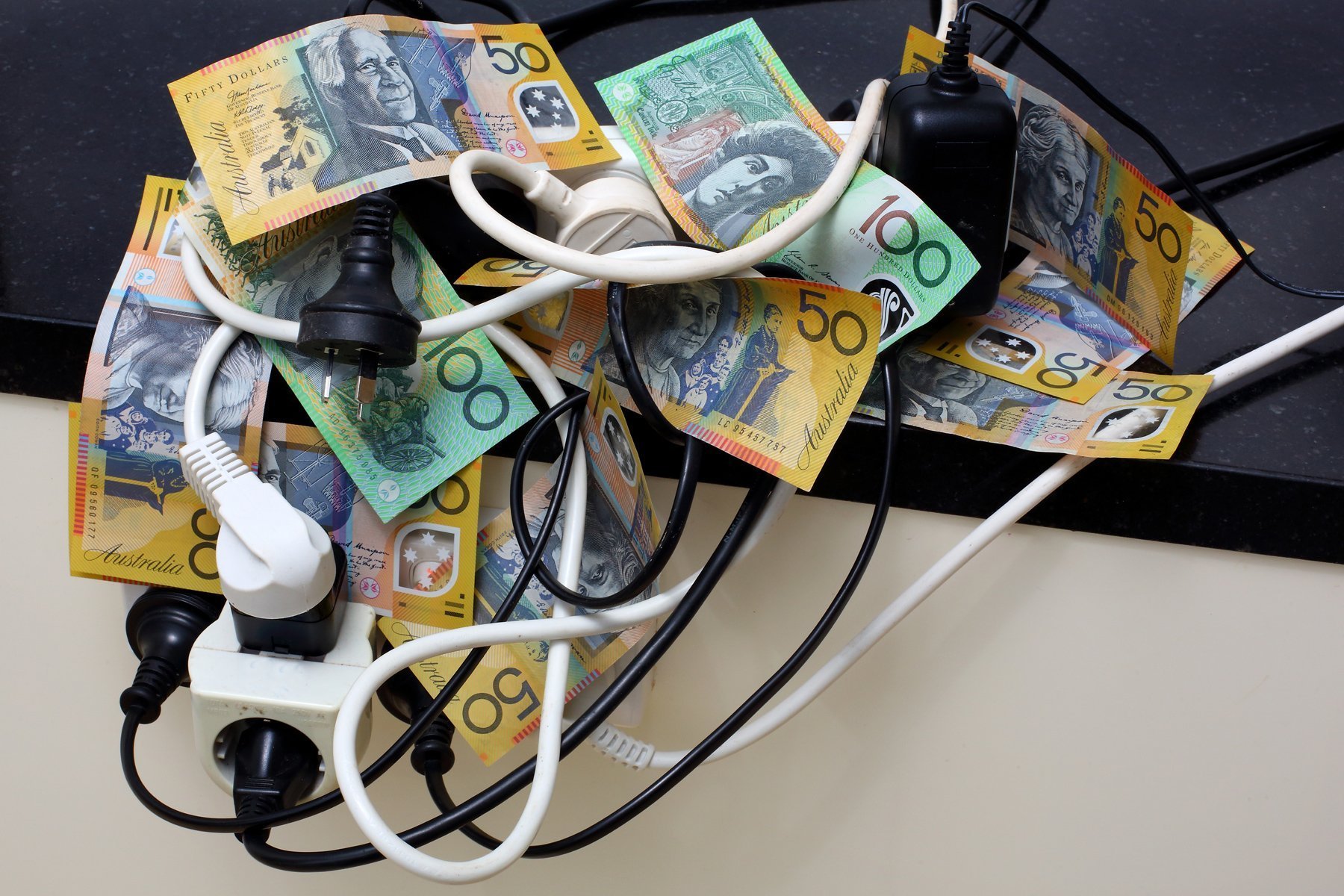 A table stacked with a pile of Australian dollar bills.