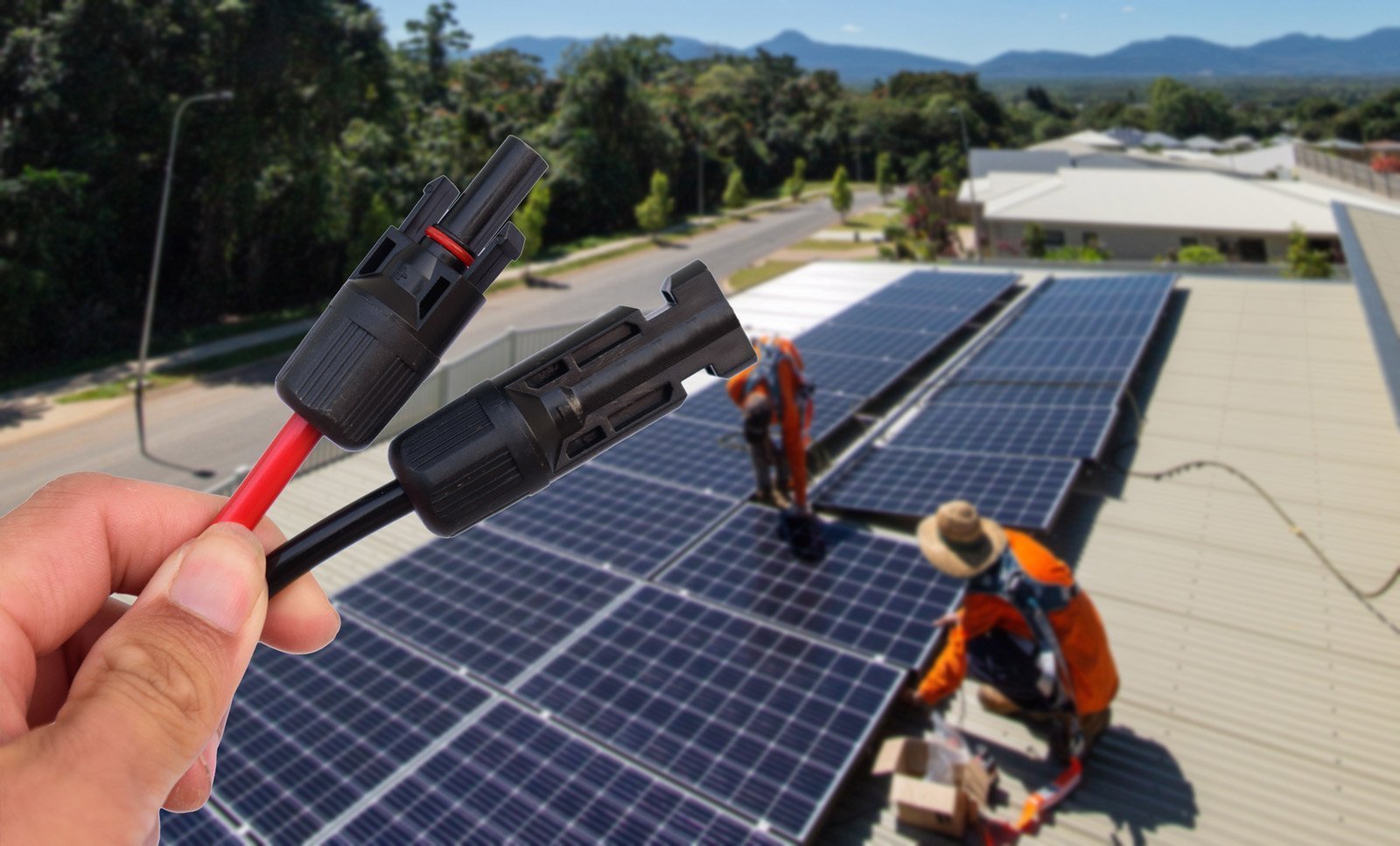 A person is holding a wire on a solar panel in Cairns.