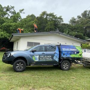 A Solar-powered truck is parked in front of a house.