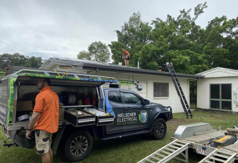 Two men working on the installation of Solar Panels on the roof of a house for Hielscher Electrical, specializing in Solar Power.