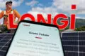 A man stands near solar panels with the lush mountains of Far North Queensland in the background; a phone displays LONGi’s website and commitment to green energy—highlighting LONGi Solar Cairns. The word "LONGI" appears prominently in bold letters.