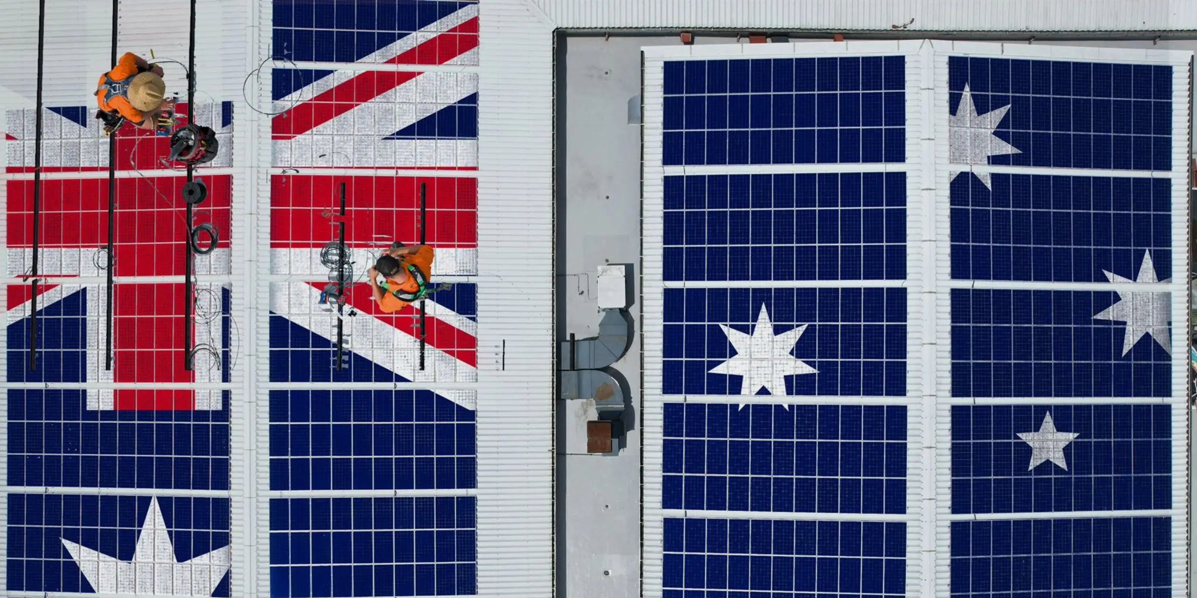 Aerial view of a Cairns rooftop with Tindo solar panels in an Australian flag design, two Hielscher Electrical Solar Installers.
