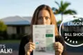 A woman in Cairns stands outside holding an Ergon Energy bill, looking surprised. Text: "Ergon Energy Bill Shock," "Let's Talk!" with a solar panel icon.