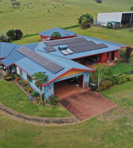 An aerial view of a home with solar panels on the roof in Cairns.